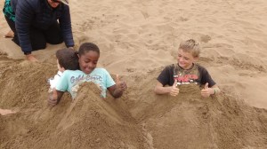 Soledad and Monkey Island crew playing in the sand